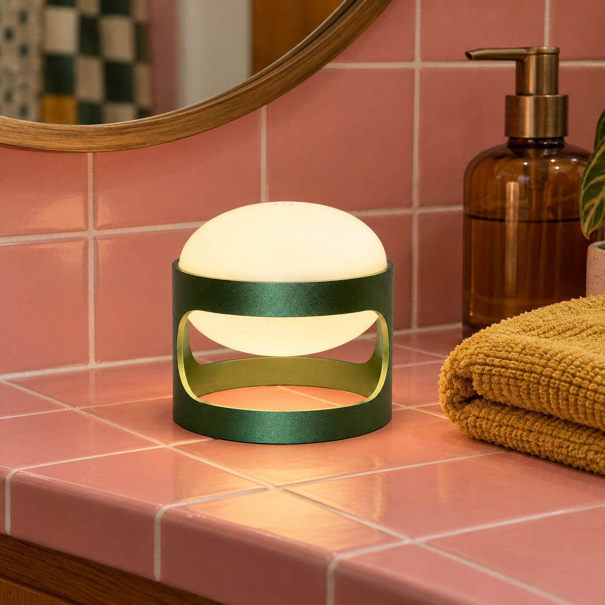 Lotus Mini cordless lamp in Deep Forest Green on a pink tiled bathroom counter